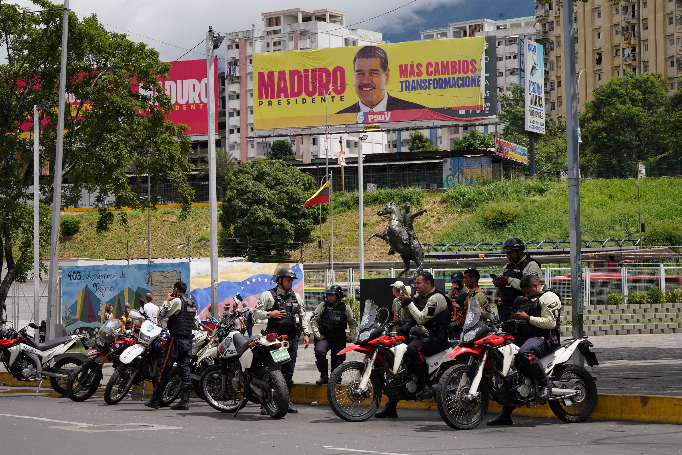 Policiais ao lado de outdoor com imagem do presidente da Venezuela, Nicolás Maduro, em Caracas
31/07/2024
REUTERS/Alexandre Meneghini