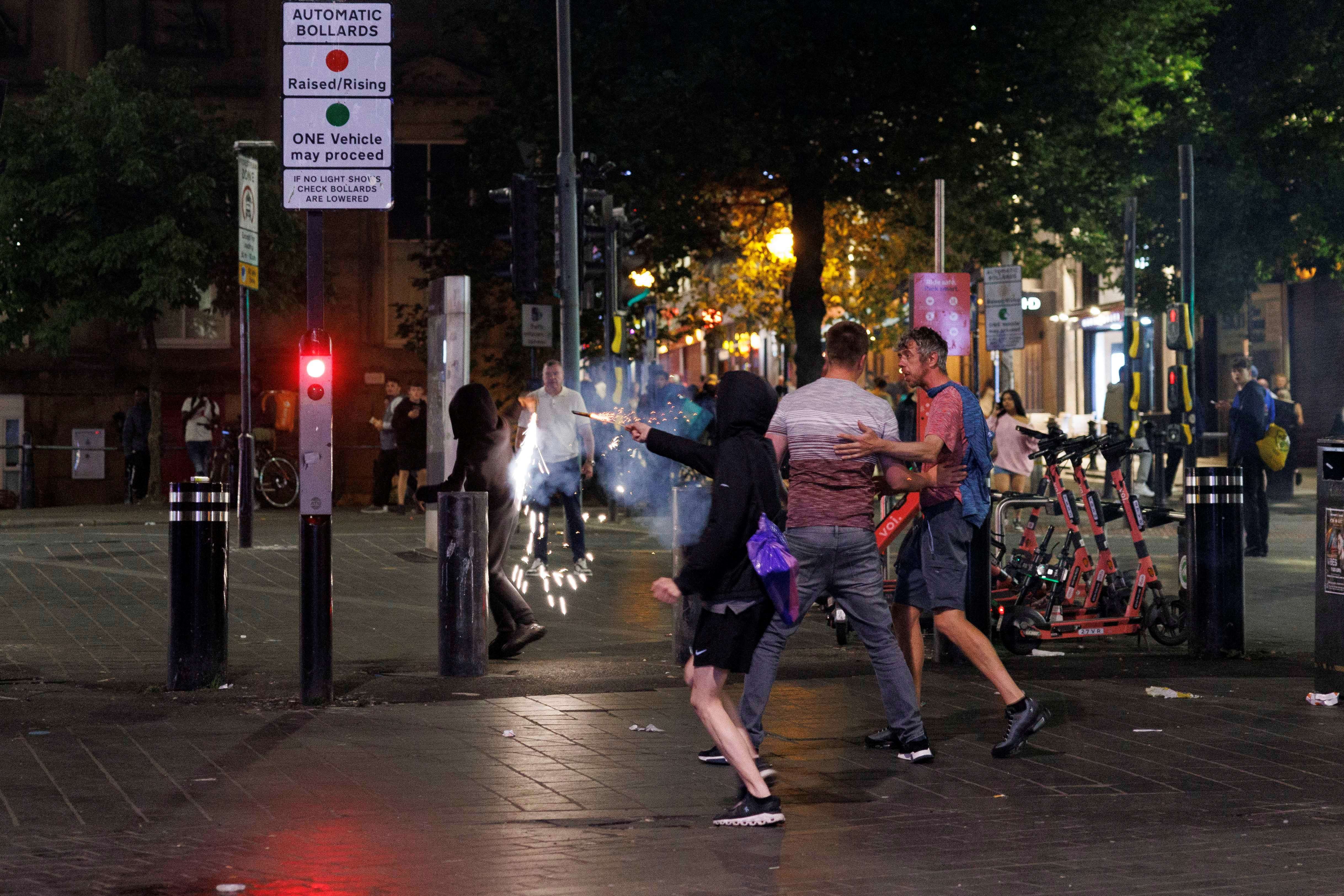 Manifestantes disparam fogos de artifício contra a polícia em Liverpool, durante protesto contra a imigração ilegal 03/08/2024 (Foto: Belinda Jiao/Reuters)