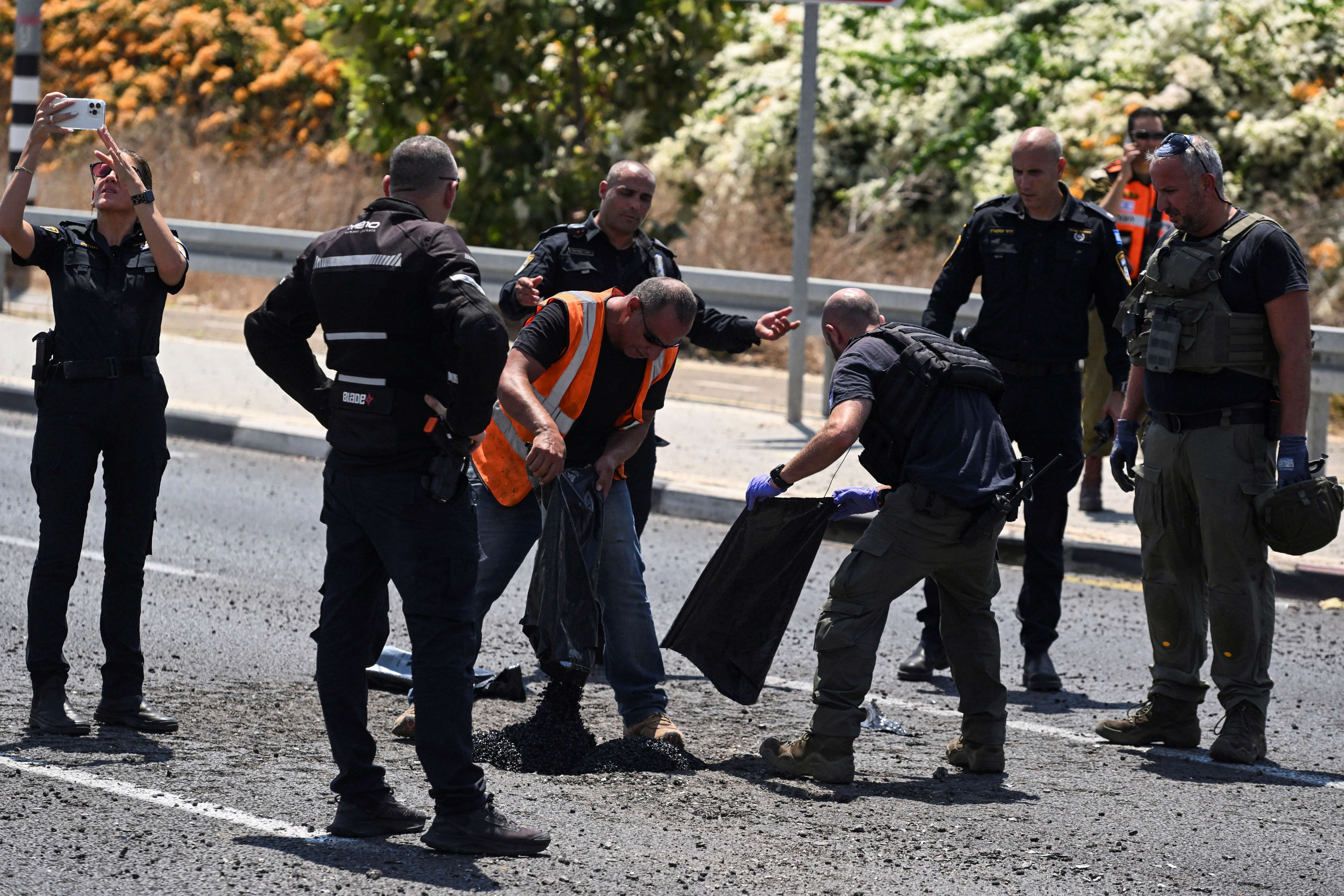 Autoridades israelenses observam impacto de projétil em Nahariya - 6/8/2024 (Foto: Rami Shlush/Reuters)