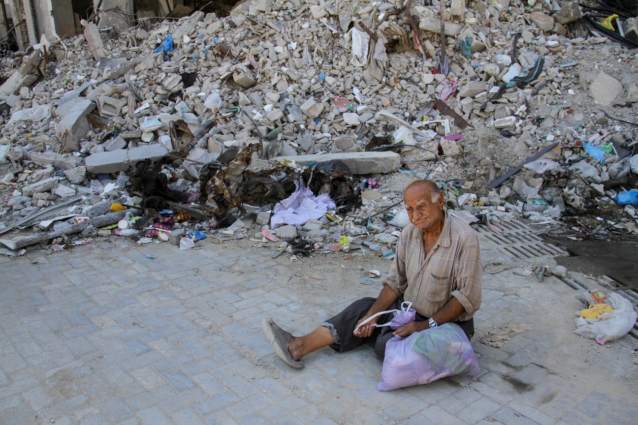 A Palestinian man sits in front of the rubble of a house at the site where a makeshift pastry shop was hit by an Israeli strike a day earlier, amid Israel-Hamas conflict, in Jabalia refugee camp in the northern Gaza Strip September 3, 2024. REUTERS/Mahmoud Issa