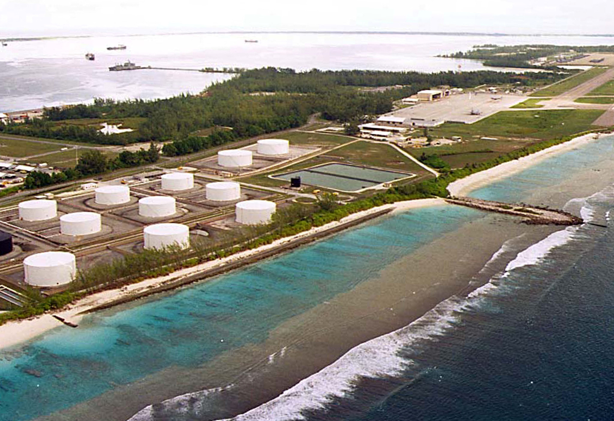 FILE PHOTO: File photo of fuel tanks at the edge of a miltary airstrip on Diego Garcia, largest island in the Chagos archipelago and site of a major United States military base in the middle of the Indian Ocean leased from Britain in 1966. Exiled inhabitants of Diego Garcia began a challenge July 17 to a British government decision to kick them off the remote island 30 years ago to make way for the U.S. base. Thousands of islanders from the 65-island Chagos archipelago, many of them born in exile in Mauritius, want Britain to return them to their homeland. clh/HO/U.S.    CLH//File Photo