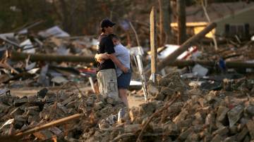 BAY ST. LOUIS, MS - SEPTEMBER 14: Alison Schulz embraces Robert Butsch in front of what was Schulz`s home September 14, 2005 in Bay St. Louis, Mississippi. Thousands of residents in the Gulf Coast are still without electricity or access to basic amenities after Hurricane Katrina swept through the area seventeen days ago over two weeks ago. (Photo by Spencer Platt/Getty Images)